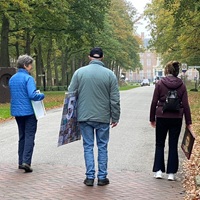 Drie schilders met hun schilderij lopend op weg naar het Slot Zeist voor de expositie van de Toets